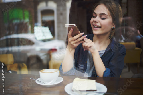 pretty woman in a cafe a cup of drink communication relaxation