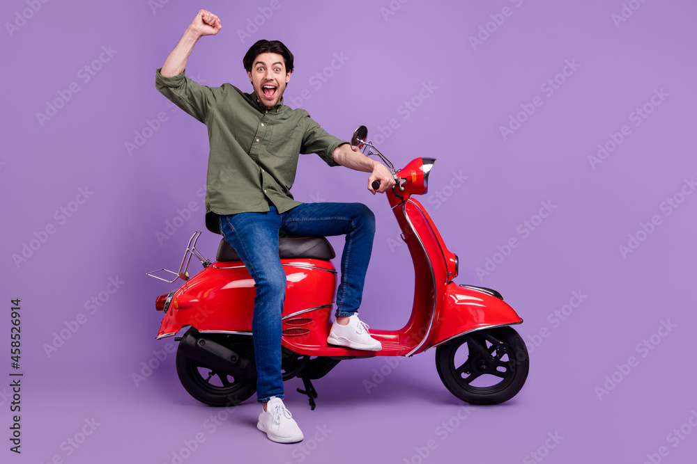 Full length photo of amazed happy cheerful man winner crazy mood enjoy isolated on purple color background Full length photo of amazed happy cheerful man winner crazy mood enjoy isolated on purple color background