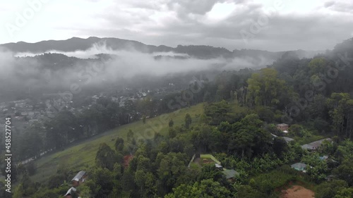 aerial drone shot flying by cloudy misty foggy lushoto village in usambara mountains remote place in tanga province tanzania africa photo