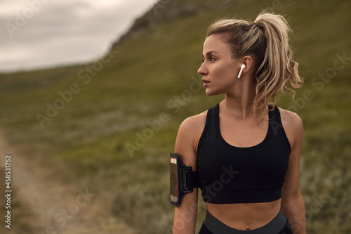 Sporty woman with gadgets in nature