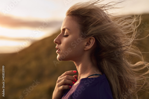 Graceful woman on windy day in nature
