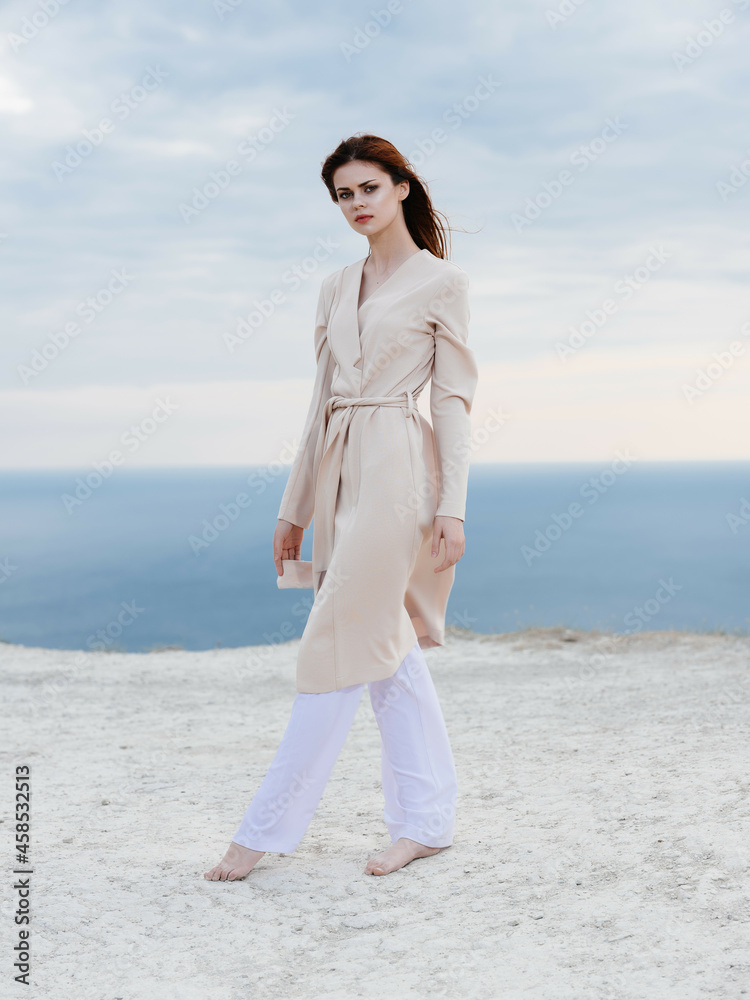 attractive woman in coat sand summer model Travel attractive woman in coat sand summer model Travel