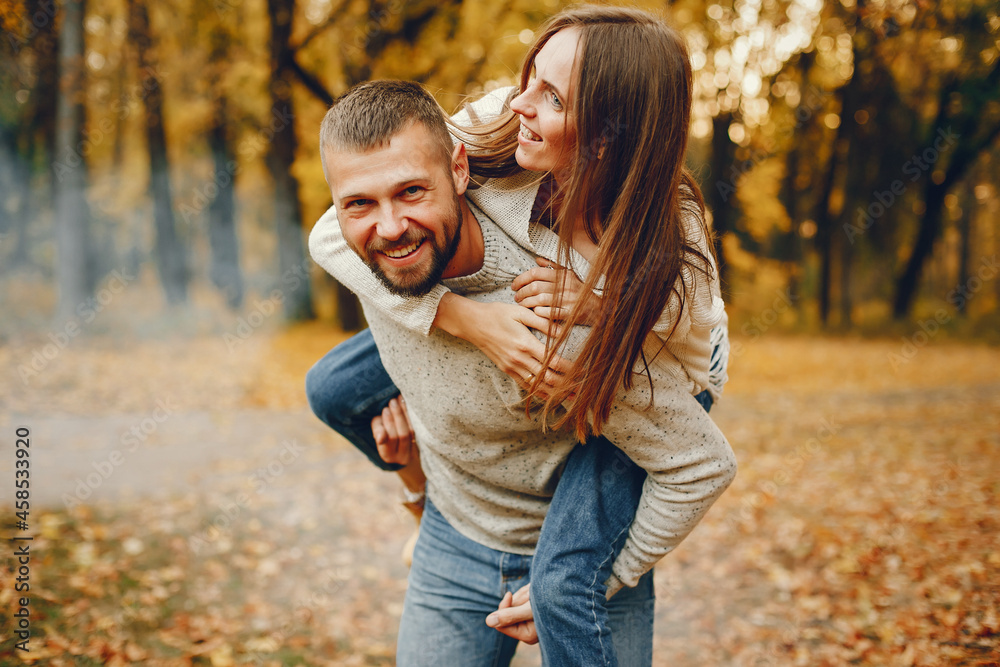 Elegant couple spend time in a autumn park Elegant couple spend time in a autumn park