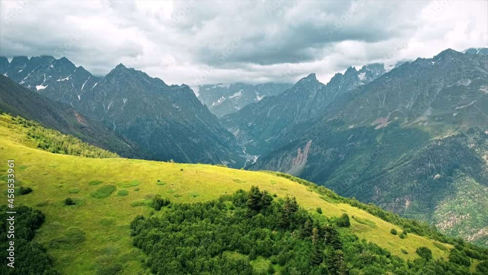 Aerial drone view of nature in Georgia. Caucasus Mountains, greenery, valleys, lush clouds Aerial drone view of nature in Georgia. Caucasus Mountains, greenery, valleys, lush clouds