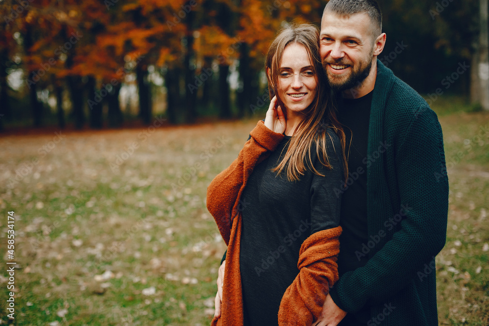 Elegant couple spend time in a autumn park Elegant couple spend time in a autumn park
