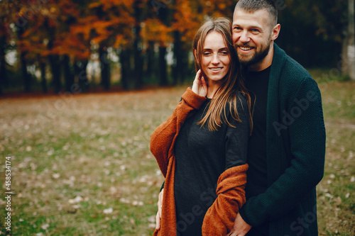 Elegant couple spend time in a autumn park