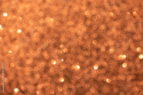 Abstract brown blurred bokeh background. Glitter shining lights. Festive and celebration backdrop for holiday, christmas and new year design, stock photo