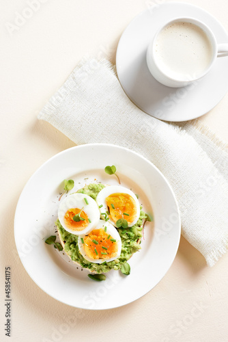 Avocado egg sandwich and cup of coffee