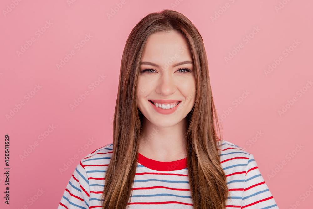 Photo of dreamy lovely pretty lady beaming shiny smile on pink background Photo of dreamy lovely pretty lady beaming shiny smile on pink background
