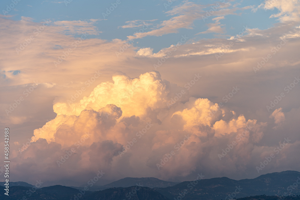 Cloudy orange sunset over the mountains with dramatic clouds Cloudy orange sunset over the mountains with dramatic clouds