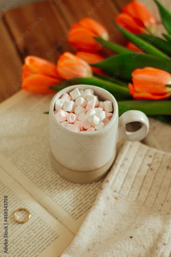 drink with marshmallow and tullips and book on wooden background drink with marshmallow and tullips and book on wooden background