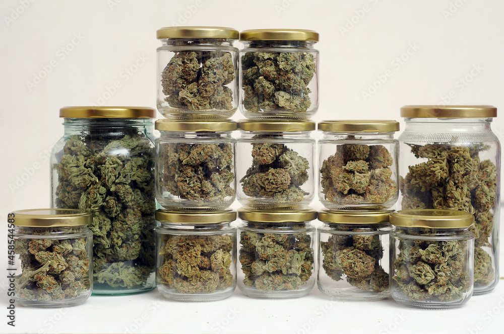 Cannabis drying and curing. Marijuana buds in glass jars. Eco container. Hemp growing concept. Cannabis drying and curing. Marijuana buds in glass jars. Eco container. Hemp growing concept.