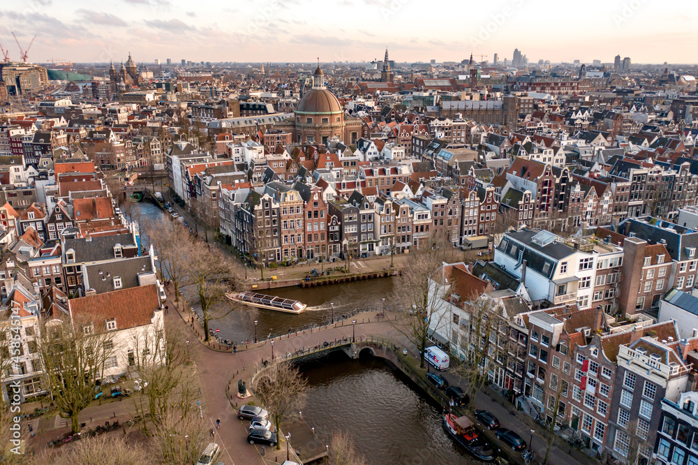 Sunset Over Amsterdam City with its Canals and Waterways Aerial View
