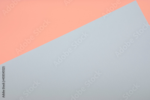 Pale coral and grey color paper background, copy space
