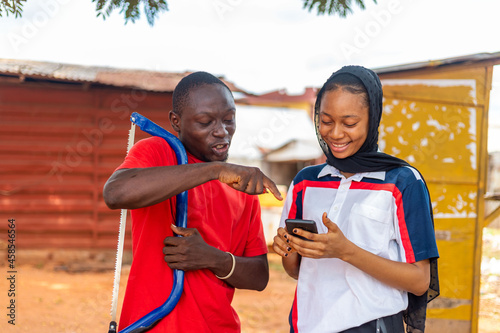 African carpenter feeling excited about what he saw on his client's phone. photo