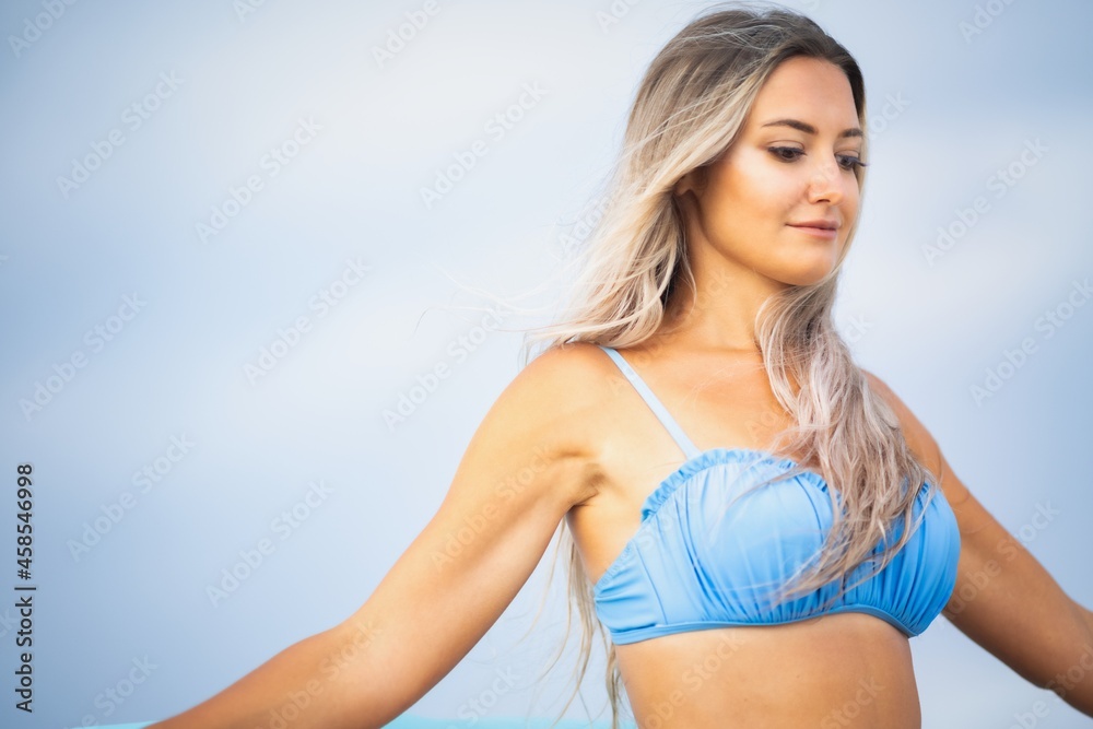 Portrait of a beautiful woman with blond hair in a blue swimsuit Portrait of a beautiful woman with blond hair in a blue swimsuit