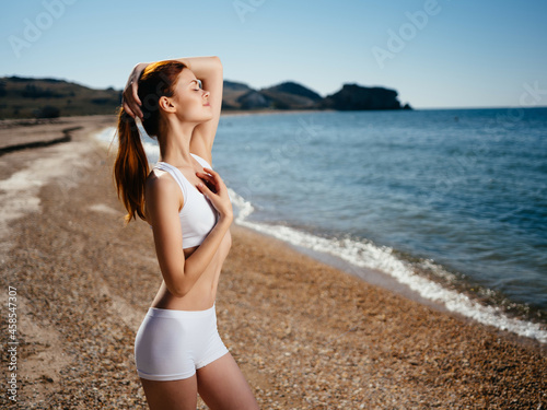 Woman in white swimsuit on the beach ocean summer