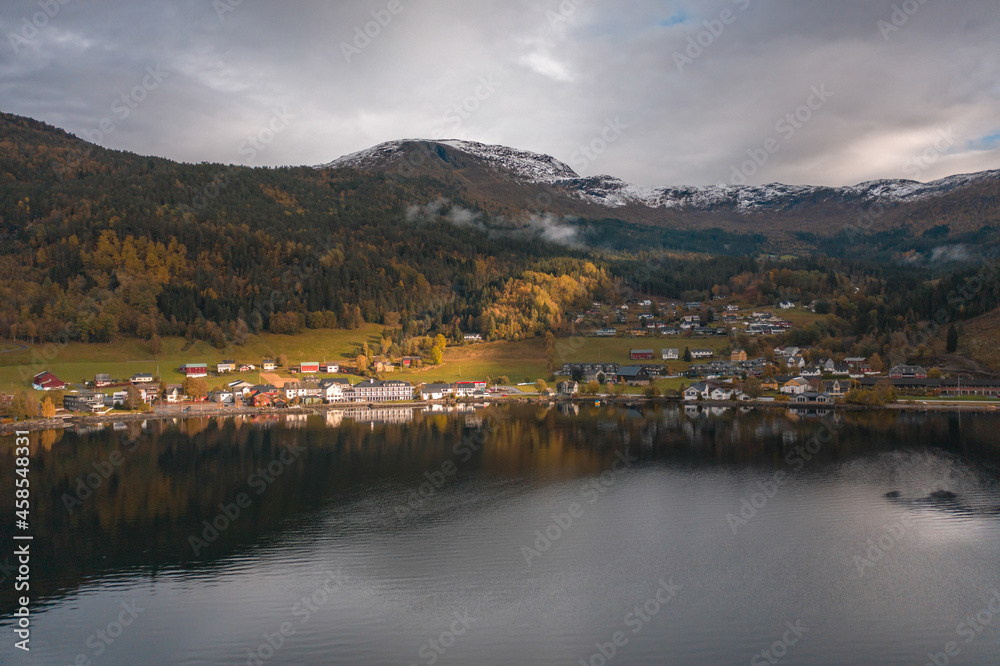 Small Town on the Shores of a Fjord in Norway Reflected in the Waters