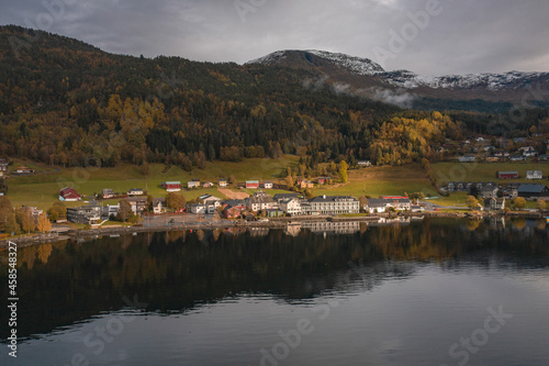 Small Town on the Shores of a Fjord in Norway Reflected in the Waters