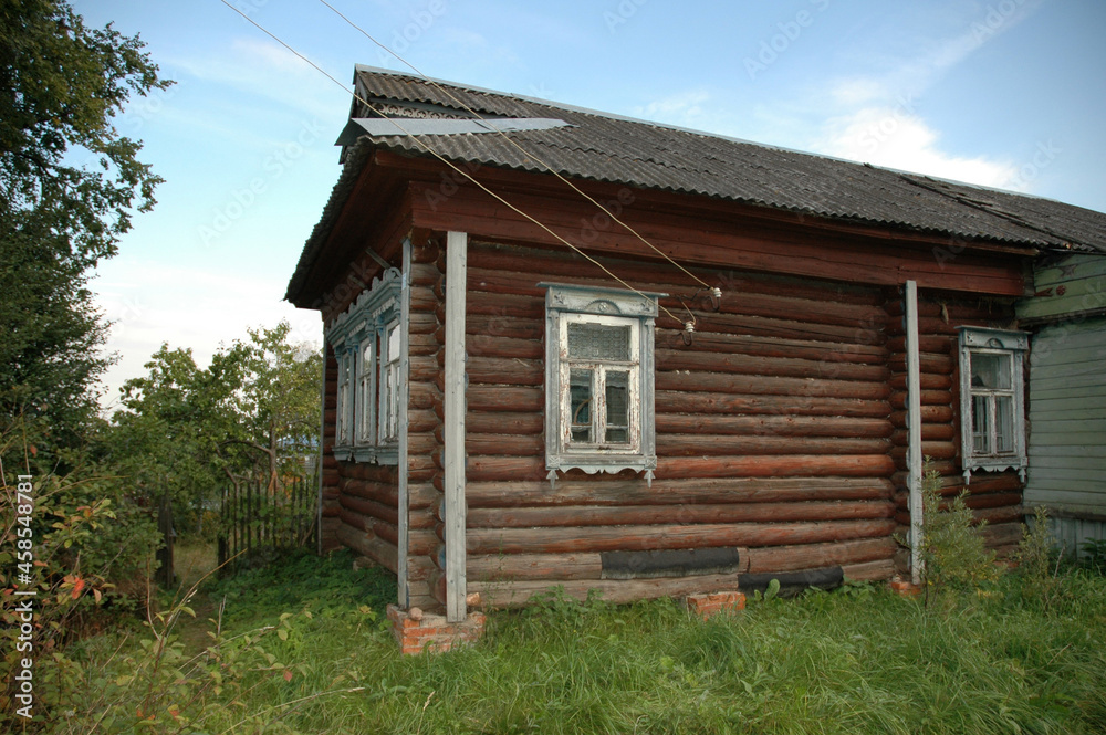 Rustic wooden house. An old crumbling house in the village. Rural landscape. Village, village. Rural landscape.