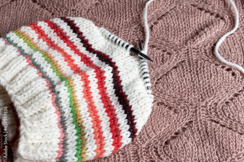 knitting a striped beanie hat on circular knitting needles