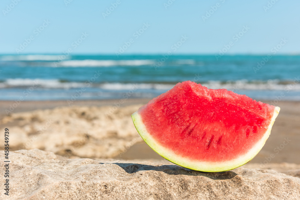Slice of watermelon on a summer beach Slice of watermelon on a summer beach