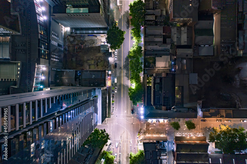 City Streets at Night Surrounded by High Rise Buildings and Skyscrapers photo