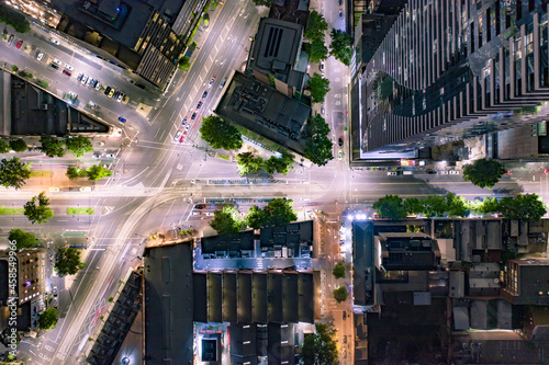 City Streets at Night Surrounded by High Rise Buildings and Skyscrapers