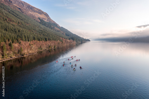 Canoeists on a Huge Lake Surrounded by Lush Forests and Mountains