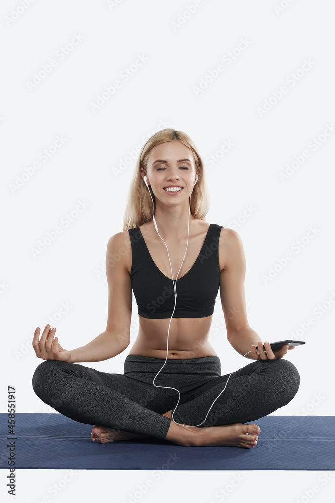 Woman meditating and listening music in headphones
