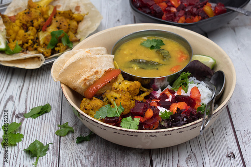 Vegan Indian bowl- sambar, cauliflower curry, chapati, rice and salad