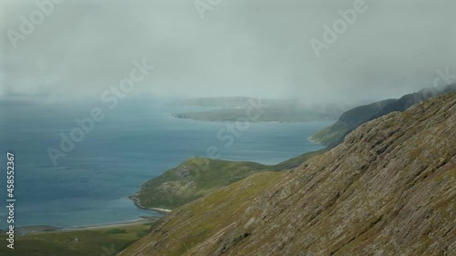 Moving clouds over a sea bay surrounded by mountains. 4k video of clouds moving over the bay. Camasunary, Isle of Skye, Scotland  photo