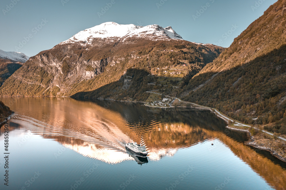 A Ferry Passing Through Geirangerfjord Surrounded by Norwegian Fjords