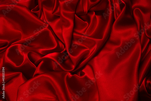 Rich and luxury red silk fabric texture background.