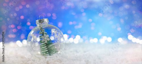Christmas gift card. Snow Ball With Christmas Tree In It And Lights On Winter Background