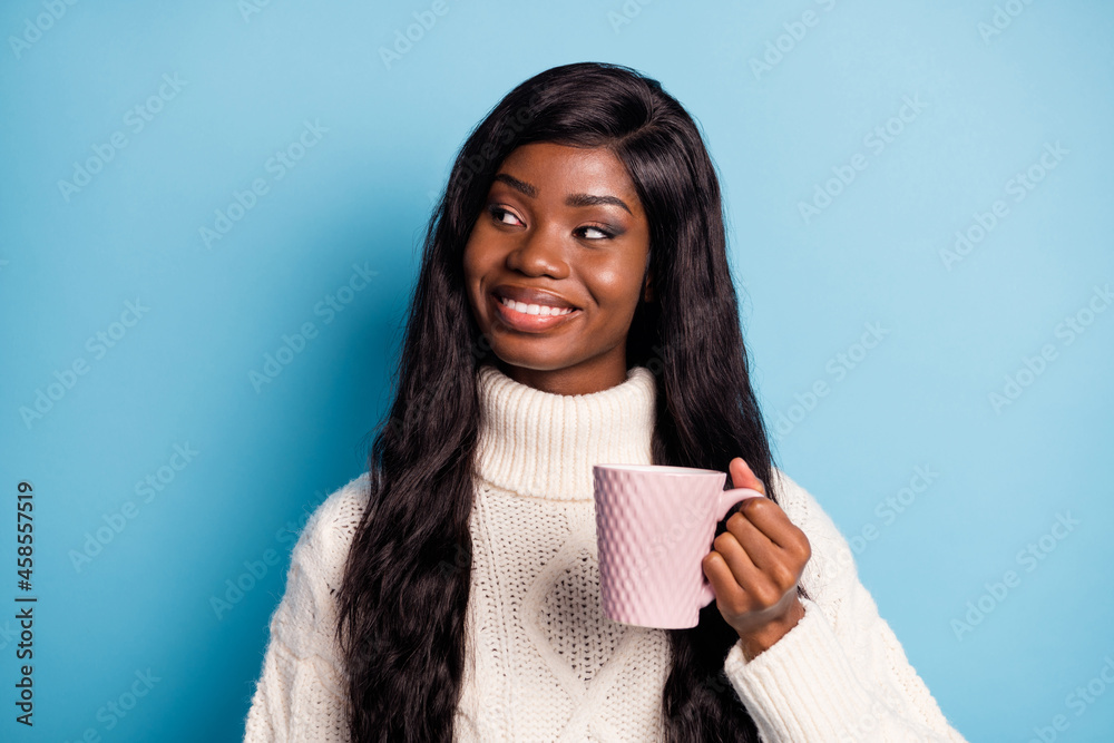 Portrait of cheerful pretty dark skin lady hand hold coffee look empty space isolated on blue color background Portrait of cheerful pretty dark skin lady hand hold coffee look empty space isolated on blue color background