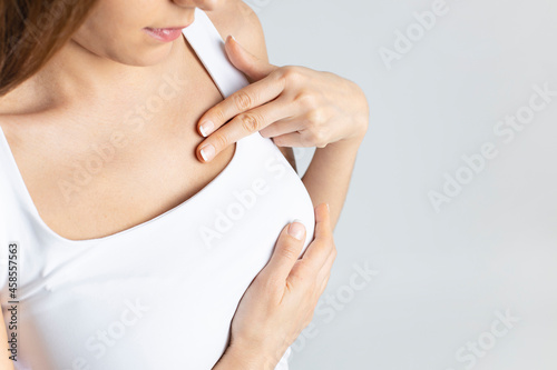 Woman do breast self exam .