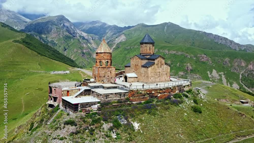 custom made wallpaper toronto digitalAerial drone view of Gergeti Trinity Church in Georgia. Caucasus Mountains, church located on the top of a hill, greenery, valley