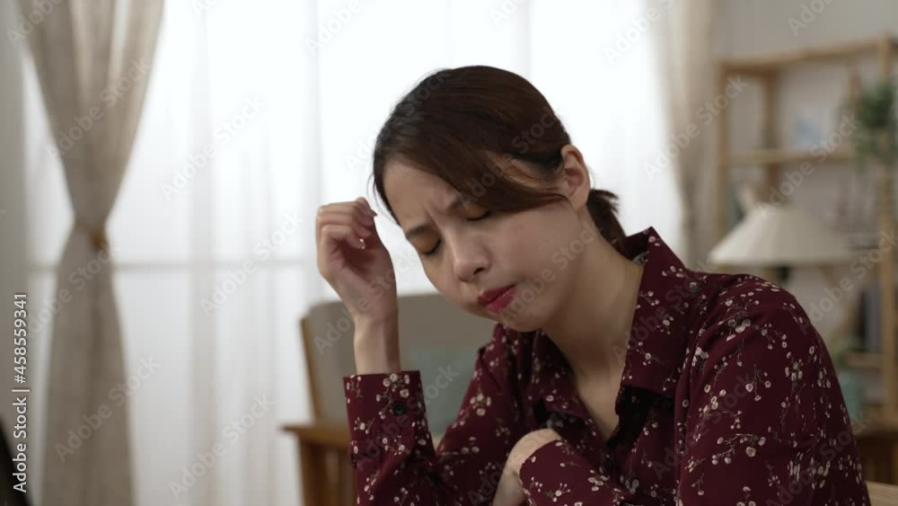 Stressed asian japanese woman using laptop. forgetful businesswoman suffering from headache after overworked on computer. Tired upset lady massaging head feeling painful while work from home time Stressed asian japanese woman using laptop. forgetful businesswoman suffering from headache after overworked on computer. Tired upset lady massaging head feeling painful while work from home time