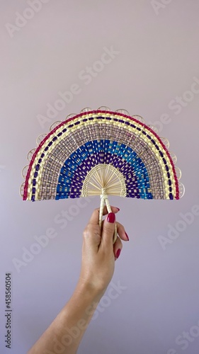 Colorful hand fan made by the Indigenous comminuty Bare in the North of Brazil.  photo