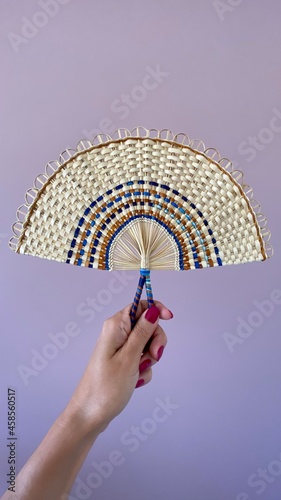 Colorful hand fan made by the Indigenous comminuty Bare in the North of Brazil.  photo