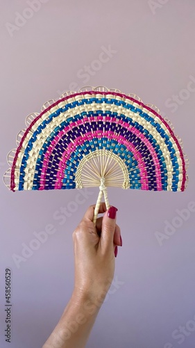 Colorful hand fan made by the Indigenous comminuty Bare in the North of Brazil.  photo