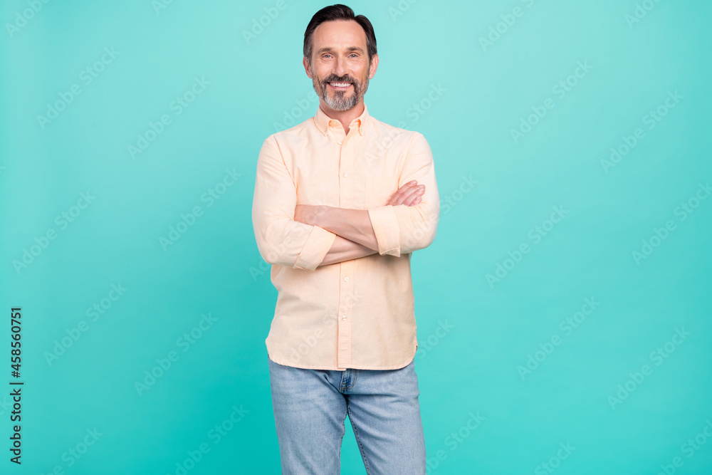 Photo of bossy mature man crossed arms wear shirt jeans isolated on teal color background Photo of bossy mature man crossed arms wear shirt jeans isolated on teal color background