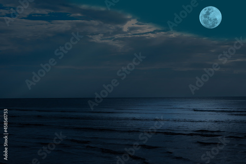 Full moon on sky over sea in the night. © Onkamon