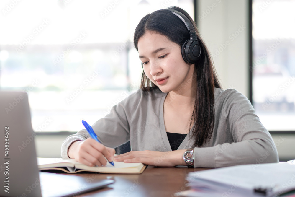 Young Woman College Student Wears Headphone Look at Laptop Study Online at Home Young Woman College Student Wears Headphone Look at Laptop Study Online at Home