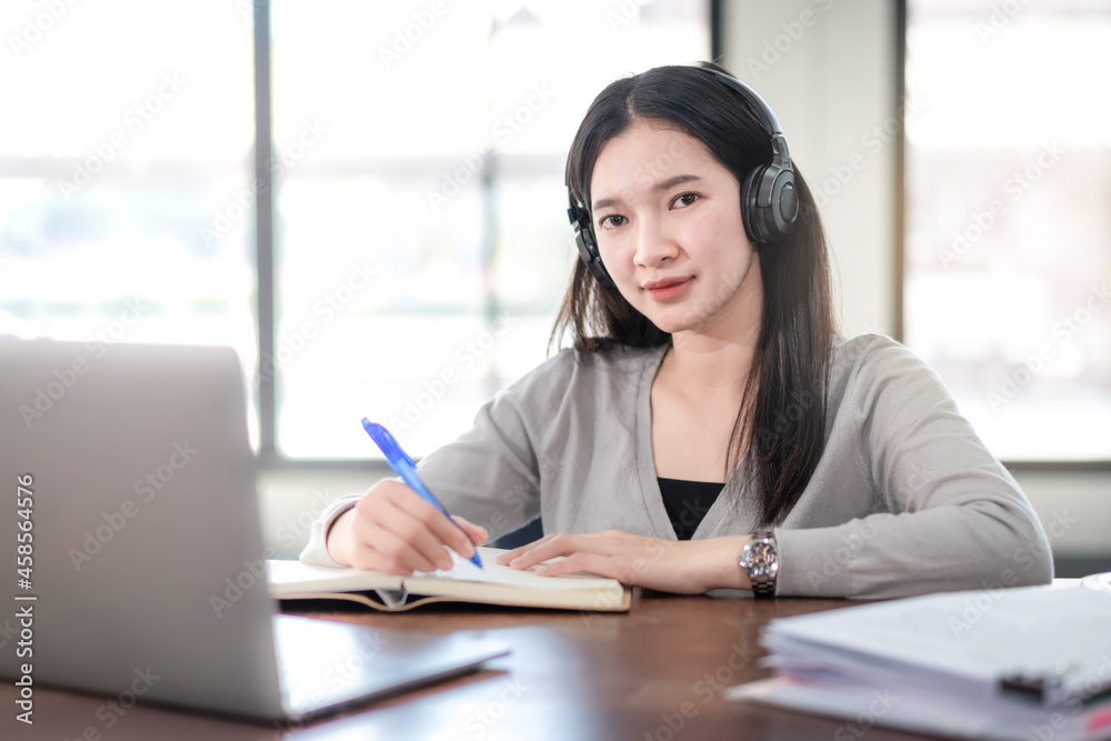 Young Woman College Student Wears Headphone Look at Laptop Study Online at Home Young Woman College Student Wears Headphone Look at Laptop Study Online at Home