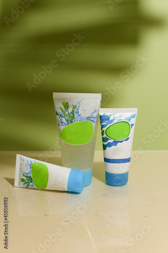 Eco friendly Bottle and tube with natural skincare cosmetics, creams or oils on light background. Plant-based beauty products