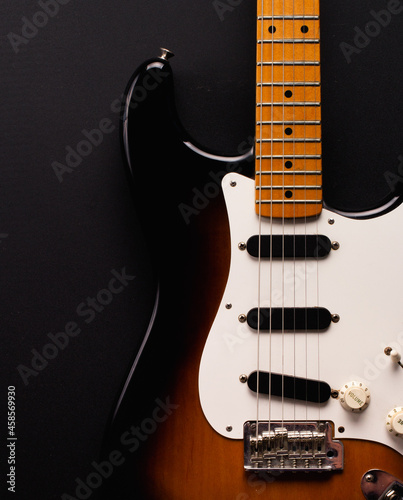 Sunburst electric guitar with maple neck on black