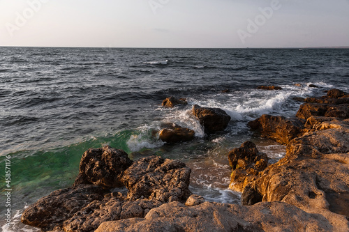 Stones on the seashore. Rocky beach at sunset. Natural background. © MadCat13Shoombrat