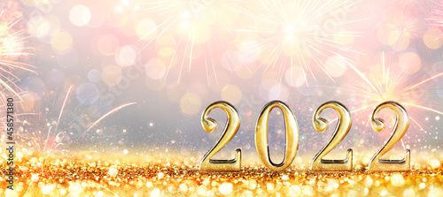 2022 New Year Celebration - Golden Numbers On Glitter With Fireworks And Defocused Background